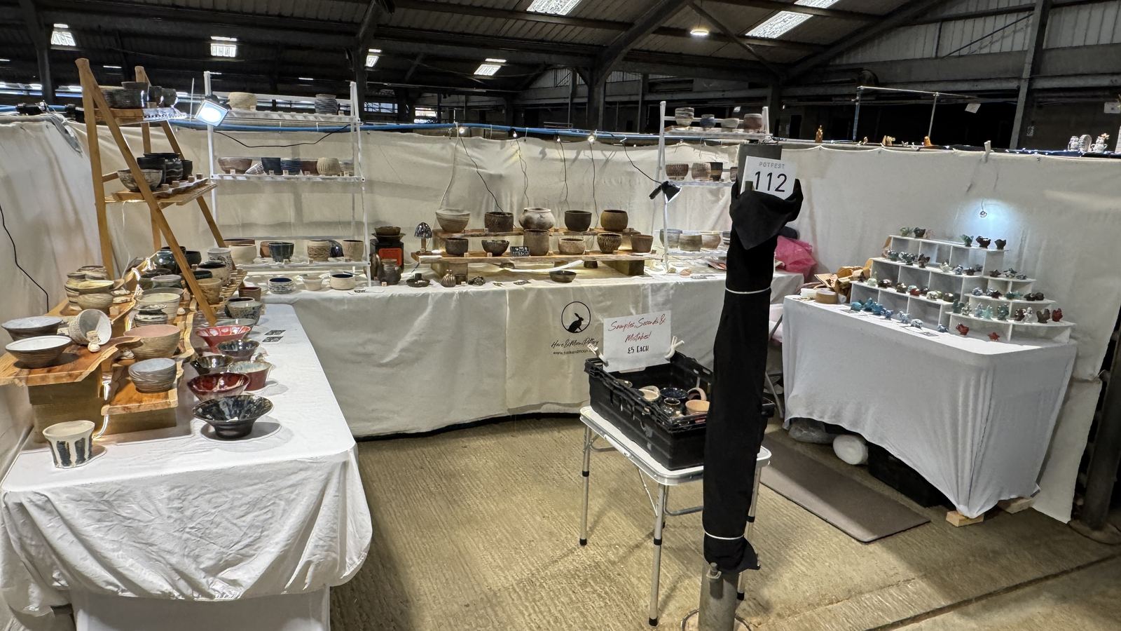 The Hare and Moon stand at Potfest in the Pens, with shelves of pots